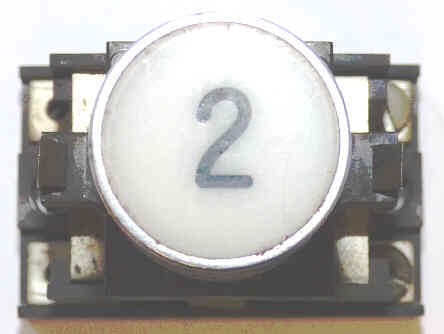 BUTTON, ASSEMBLY, WHITE WITH BLACK # 2 HORIZONTAL ARMOR # B761003