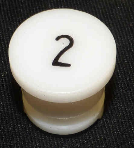BUTTON, WHITE, TYPE 'H', MARKED # 2 IN BLACK HAUGHTON # 3-40080-02