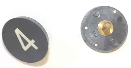 BUTTON, 7/8, BLACK, HOT STAMPED IN WHITE, MARKED 4 OTIS # 323BL2