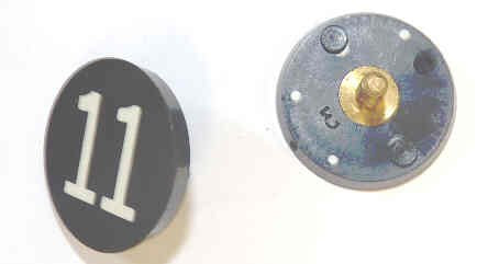 BUTTON, 7/8, BLACK, HOT STAMPED IN WHITE, MARKED 11 OTIS # 323BL2