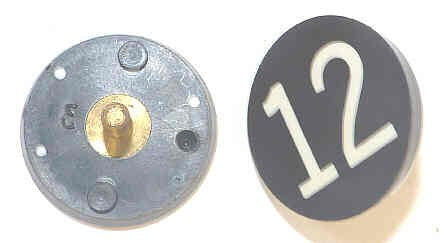 BUTTON, 7/8, BLACK, HOT STAMPED IN WHITE, MARKED 12 OTIS # 323BL2