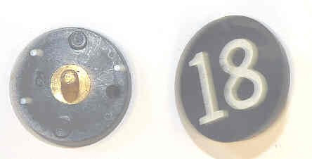 BUTTON, 7/8, BLACK, HOT STAMPED IN WHITE, MARKED 18 OTIS # 323BL2