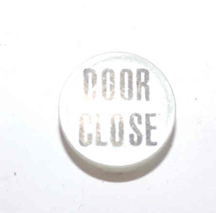 INSERT, BUTTON, 7/8 DIA., WHITE, MARKED DOOR CLOSE IN BLACK ARMOR # 11133-01