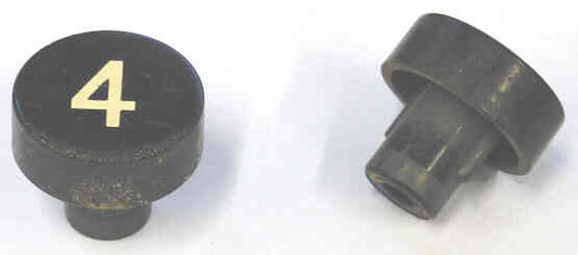 BUTTON, BLACK, MARKED # 4, 1 DIAMETER OTIS # 323BD1-4