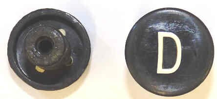 BUTTON, BLACK, MARKED D, 1 DIAMETER OTIS # 323BD1-D