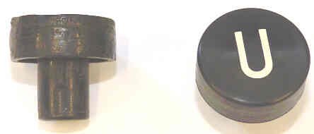 BUTTON, BLACK, MARKED U, 1 DIAMETER OTIS # 323BD1-U