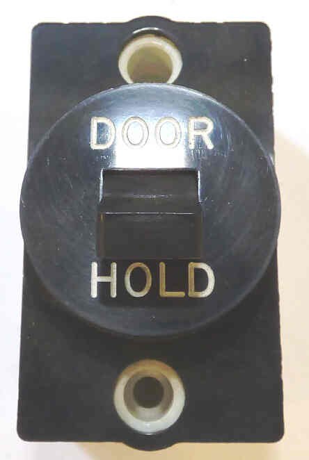 SWITCH, BLACK BEZEL, TOGGLE, ENGRAVED DOOR HOLD GAL # PB6-0013V