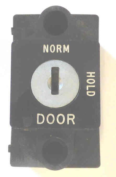 SWITCH, KEYED, BLACK BEZEL, VERTICAL, ENGRAVED NORM-HOLD-DOOR