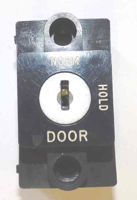 SWITCH, KEYED, BLACK BEZEL, VERTICAL, ENGRAVED NORM-HOLD-DOOR