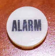 INSERT, BUTTON, 7/8 DIA., WHITE, MARKED ALARM IN BLACK ARMOR # 11133-01