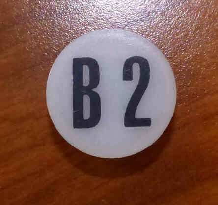 INSERT, BUTTON, 7/8 DIA., WHITE, MARKED B2 IN BLACK ARMOR # 11133-01