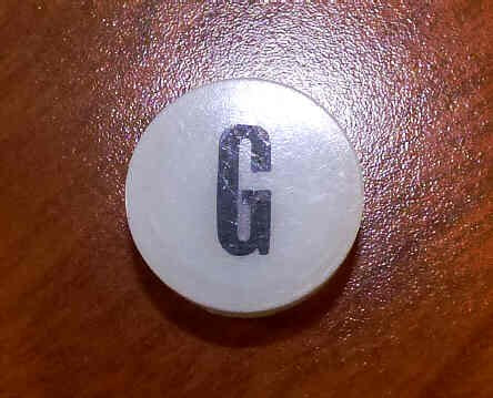 INSERT, BUTTON, 7/8 DIA., WHITE, MARKED G IN BLACK ARMOR # 11133-01