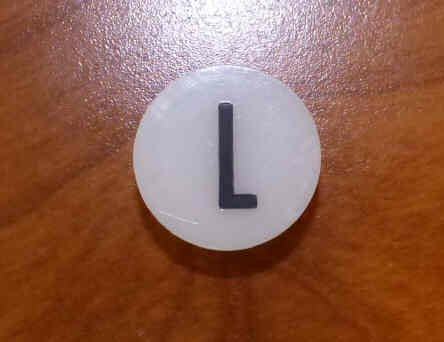 INSERT, BUTTON, 7/8 DIA., WHITE, MARKED L IN BLACK ARMOR # 11133-01