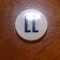 INSERT, BUTTON, 7/8 DIA., WHITE, MARKED LL IN BLACK ARMOR # 11133-01