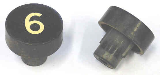 BUTTON, BLACK, MARKED # 6, 1 DIAMETER OTIS # 323BD1-6