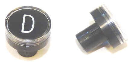 BUTTON, CLEAR CAP, 1 DIAMETER, MARKED 'D' OTIS # A323BD1-D