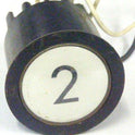 PUSHBUTTON, BLACK, ROUND, WHITE INSERT, MARKED 2 US # 167-03011-100